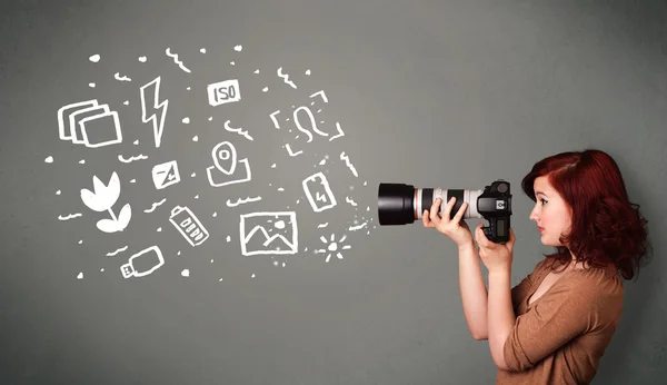 Photographer girl capturing white photography icons and symbols — Stock Photo, Image