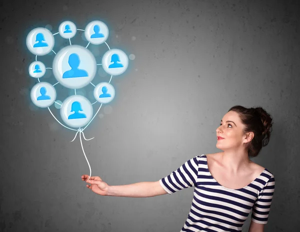 Woman holding social network balloon — Stock Photo, Image