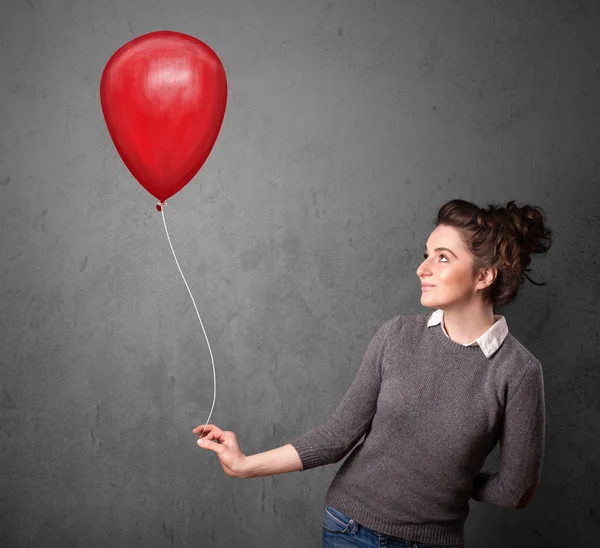 Kırmızı balon tutan kadın — Stok fotoğraf