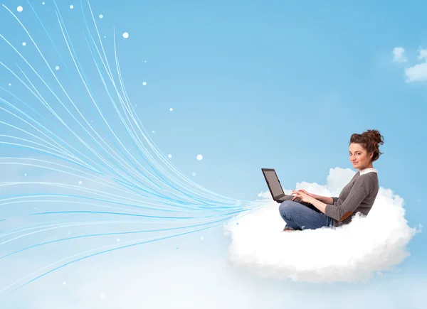 Young woman sitting in cloud with laptop — Stock Photo, Image