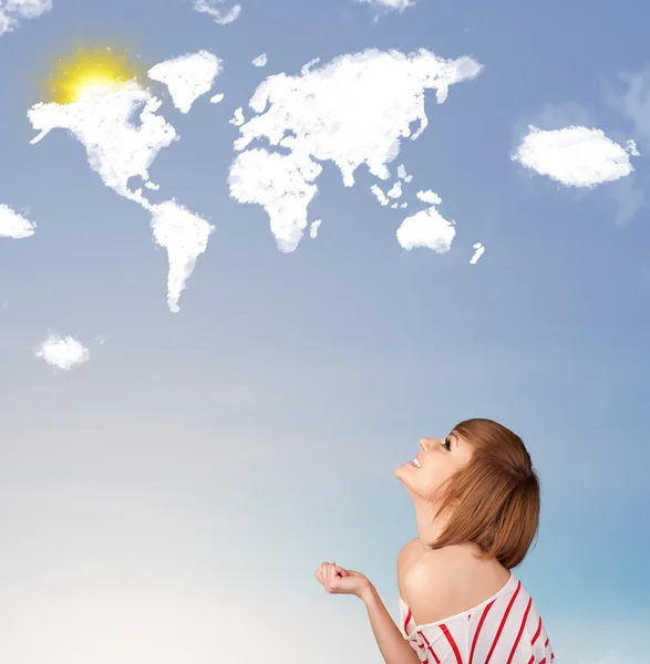 Young girl looking at world clouds and sun on blue sky — Stock Photo, Image