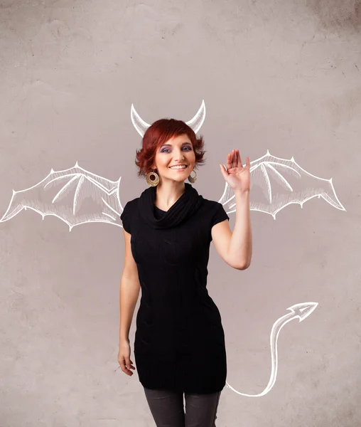 Young girl with devil horns and wings drawing — Stock Photo, Image