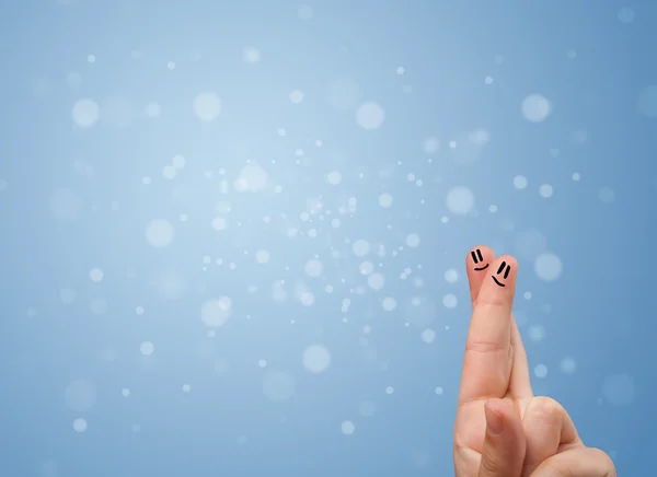 Happy finger smileys with empty blue bokeh background — Stock Photo, Image