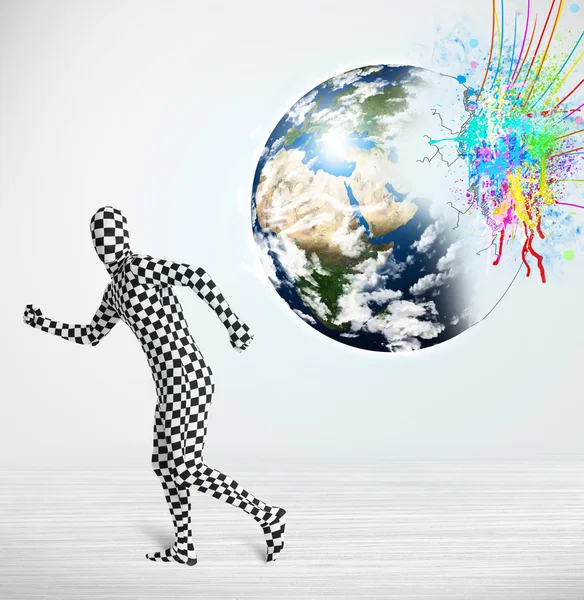 Funny man in body suit looking at colorful splatter earth — Stock Photo, Image