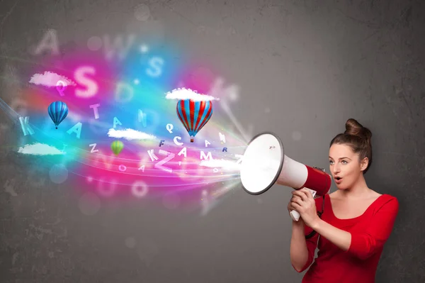 Girl shouting into megaphone and abstract text and balloons come — Stock Photo, Image