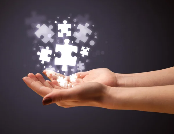 Puzzle pieces in the hand of a woman — Stock Photo, Image