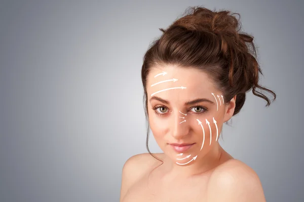 Beautiful girl with facial arrows on her skin — Stock Photo, Image