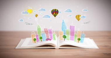 Açık kitap üzerine şehir manzarası çizimi