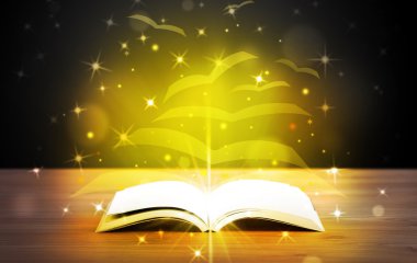 Altından parlak uçan kağıt sayfaları olan açık bir kitap