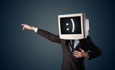 bir monitörde başını ve doğum smiley ile komik genç işadamı