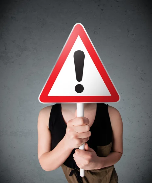 Young woman holding an exclamation road sign — Stock Photo, Image