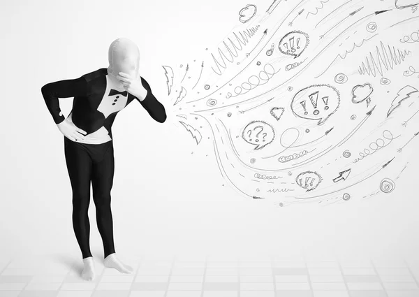 Guy in body suit morphsuit looking at sketches and doodles — Stock Photo, Image