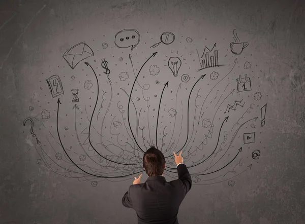 Businessman in front of a chalkboard deciding with arrows and si — Stock Photo, Image