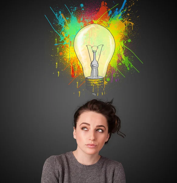 Young woman thinking with lightbulb above her head — Stock Photo, Image