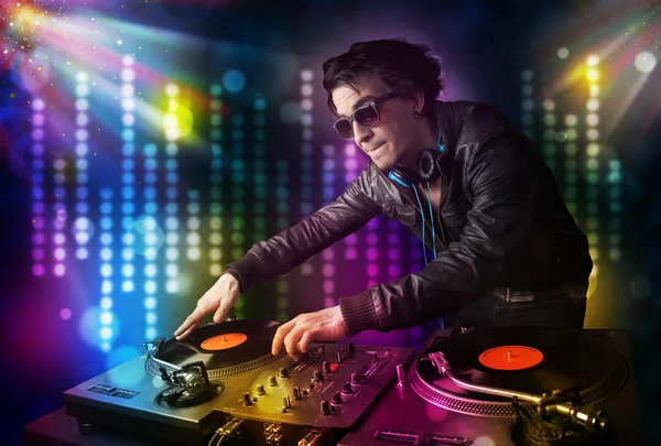 Dj playing songs in a disco with light show — Stock Photo, Image