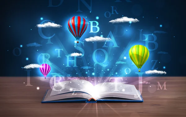 Open book with glowing fantasy abstract clouds and balloons — Stock Photo, Image