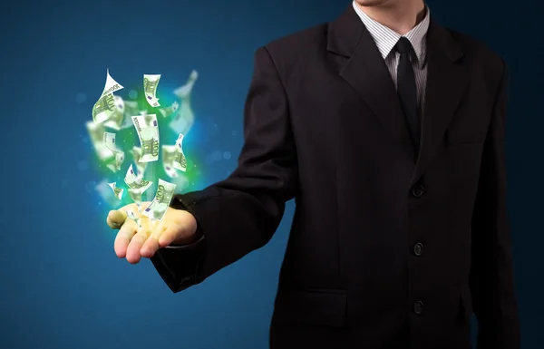 Glowing money in the hand of a businessman — Stock Photo, Image