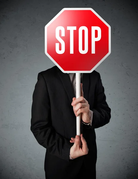 Businessman holding a stop sign — Stock Photo, Image