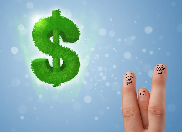 Happy smiley fingers looking at green leaf dollar sign — Stock Photo, Image