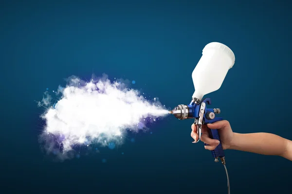 Painter with airbrush gun and white magical smoke — Stock Photo, Image