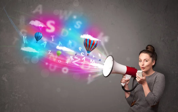 Girl shouting into megaphone and abstract text and balloons come — Stock Photo, Image