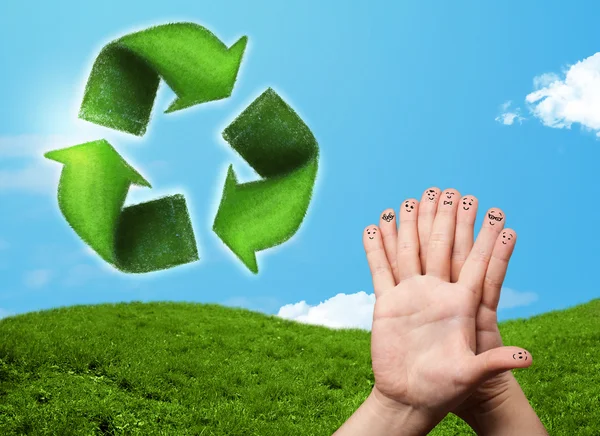 Happy smiley fingers looking at green leaf recycle sign — Stock Photo, Image