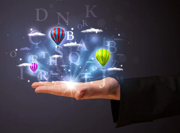 Letters and balloons in the hand of a businessman — Stock Photo, Image