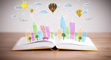 Açık kitap üzerine şehir manzarası çizimi