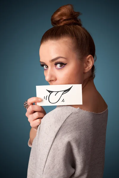 Pretty young girl holding white card with smile drawing — Stock Photo, Image