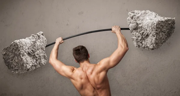 Muskulöser Mann beim Heben großer Steingewichte — Stockfoto