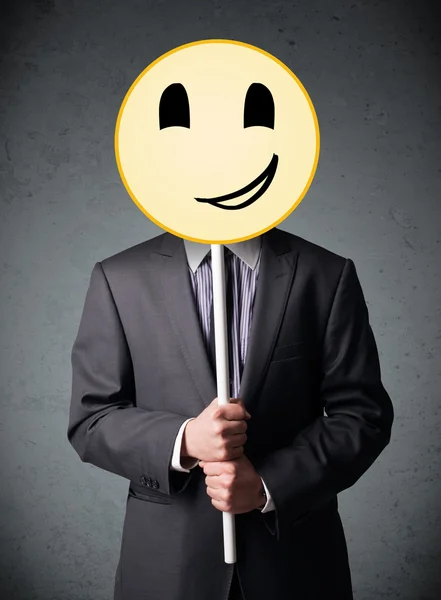 Geschäftsmann mit einem Smiley-Emoticon — Stockfoto