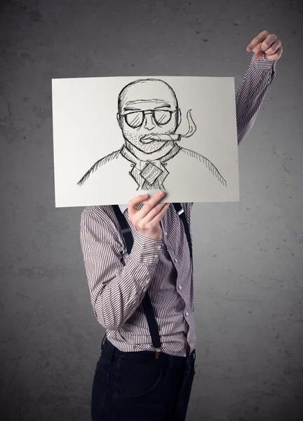 Businessman holding a cardboard with a smoking man on it in fron — Stock Photo, Image