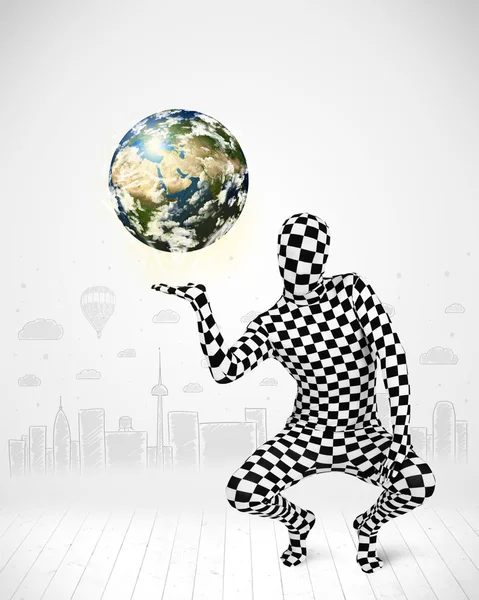 Man in full body suit holding planet earth — Stock Photo, Image