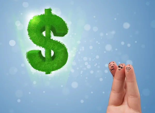 Happy smiley fingers looking at green leaf dollar sign — Stock Photo, Image