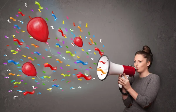 Young girl having fun, shouting into megaphone with balloons — Stock Photo, Image