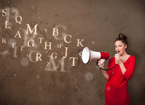 Young girl shouting into megaphone and text come out — Stock Photo, Image