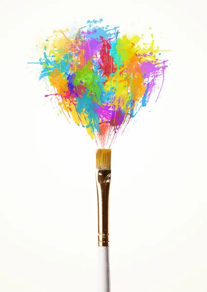 Brush close-up with colored paint splashes — Stock Photo, Image