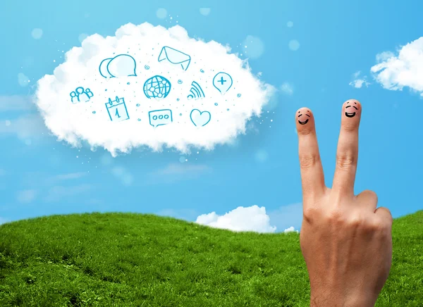 Happy smiley fingers looking at cloud with blue social icons and — Stock Photo, Image