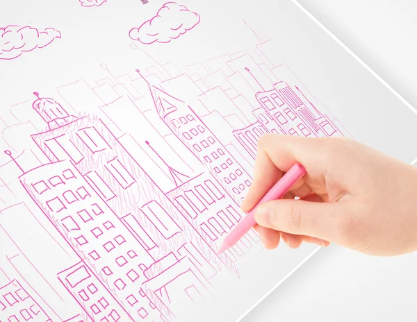 A person drawing sketch of a city with balloons and clouds on a — Stock Photo, Image