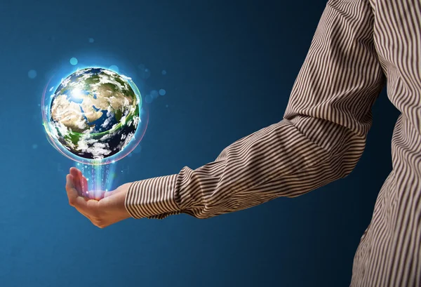 Businessman holding a glowing earth globe — Stock Photo, Image