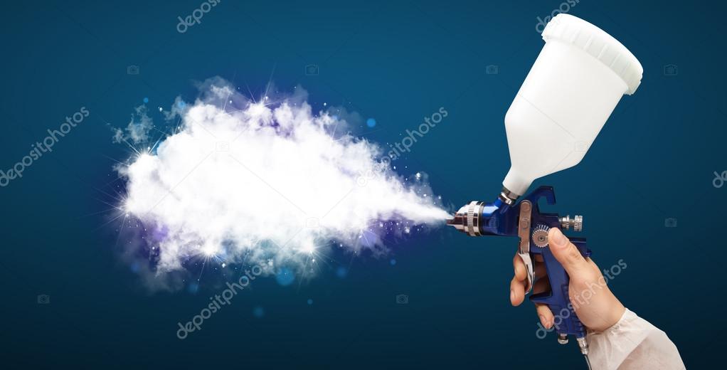 Painter with airbrush gun and white magical smoke 