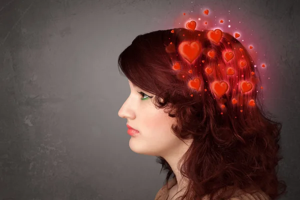 Young person thinking about love with red hearts — Stock Photo, Image