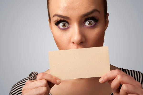 Cute girl holding white card at front of her lips with copy spac — Stock Photo, Image