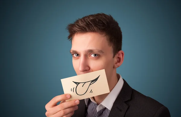 Happy businessman holding funny white card on his mouth — Stock Photo, Image