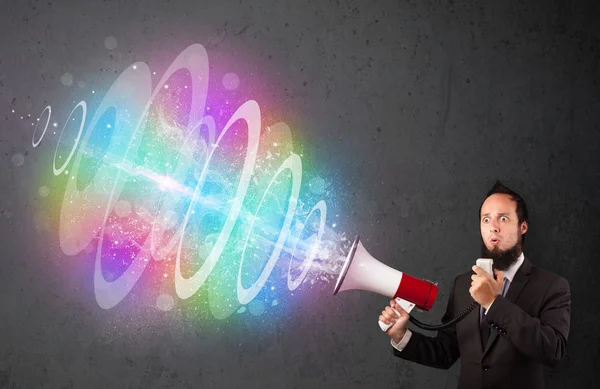 Man yells into a loudspeaker and colorful energy beam comes out — Stock Photo, Image