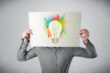 boya sıçraması ve lightbul ile bir karton tutan işadamı