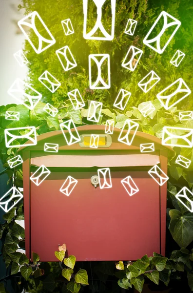 Mailbox with letter icons on glowing green background — Stock Photo, Image