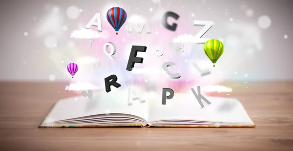 Open book with flying 3d letters on concrete background — Stock Photo, Image