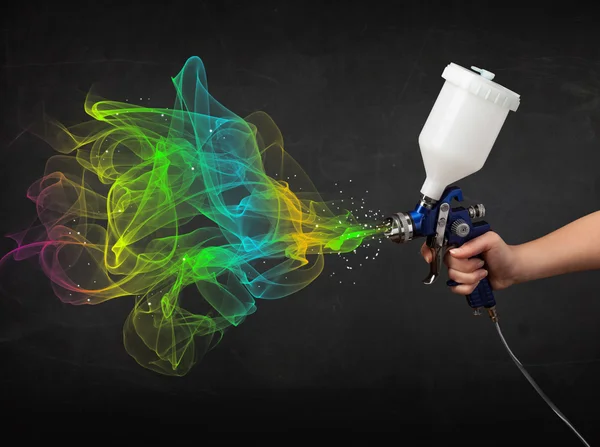 Painter working with airbrush and paints colorful paint — Stock Photo, Image