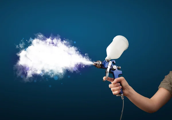 Painter with airbrush gun and white magical smoke — Stock Photo, Image